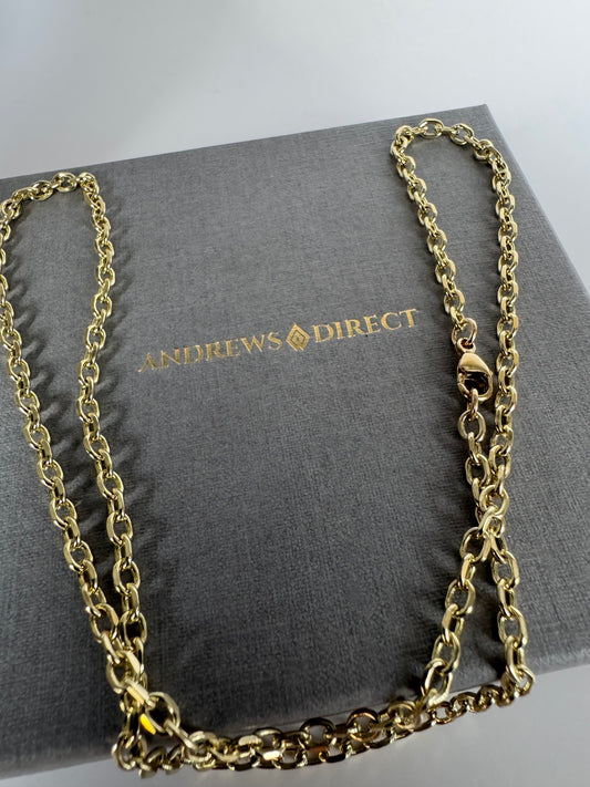 Gold chain necklace on a gray box with 'Andrews Direct' branding